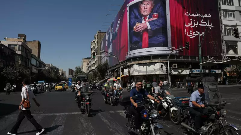 People drive near a billboard depicting U.S. President Donald Trump on a building in Tehran, Iran, September 16, 2026. Majid Asgaripour/WANA (West Asia News Agency) via REUTERS