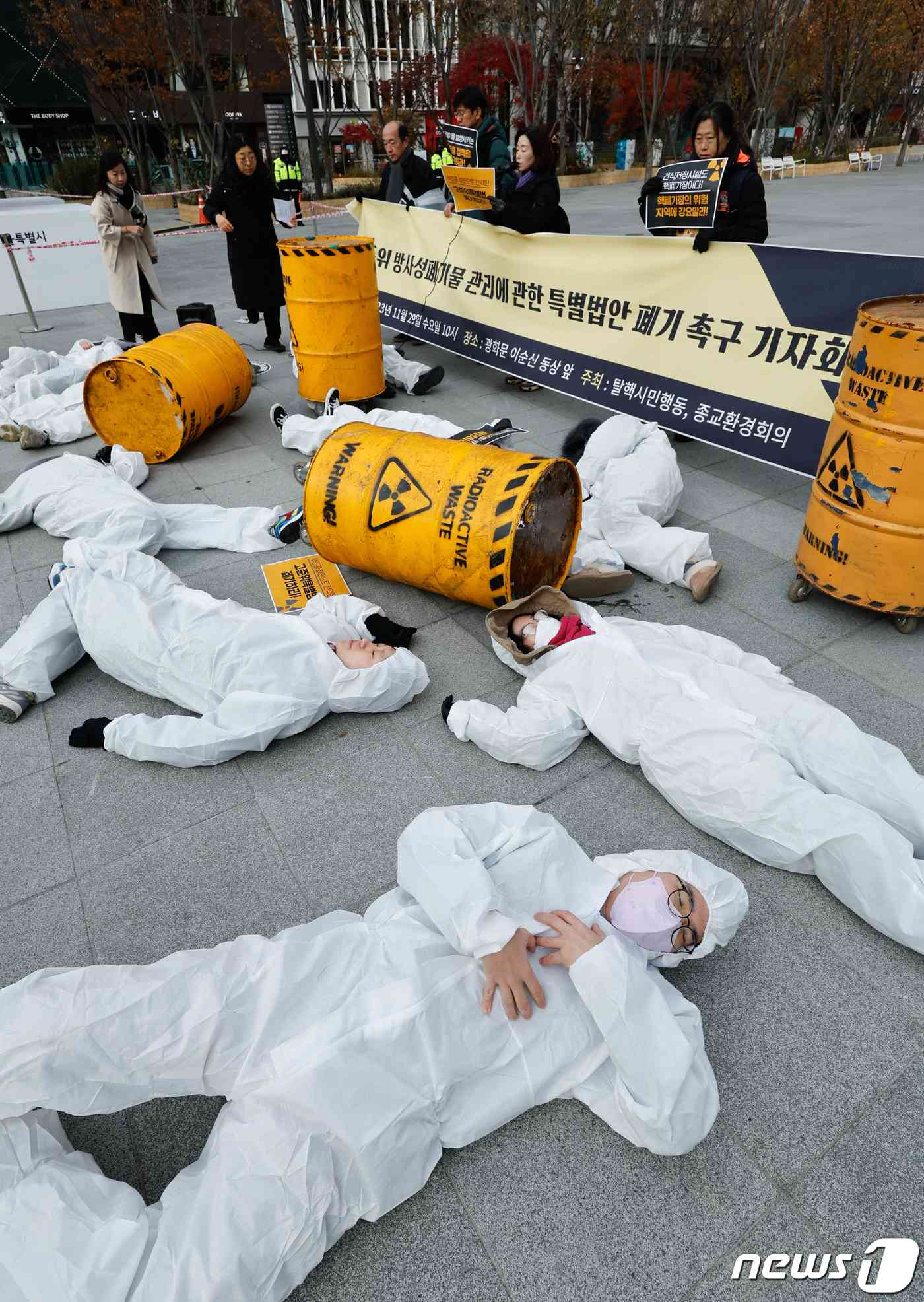 탈핵시민행동, 종교환경회의 회원들이 29일 오전 서울 종로구 광화문 광장에서 '고준위방사성폐기물특별법' 폐기를 촉구하며 쌓여있는 핵폐기물 위에 놓여있는 사람들을 상징하는 퍼포먼스를 하고 있다. 2023.11.29/뉴스1 © News1 안은나 기자