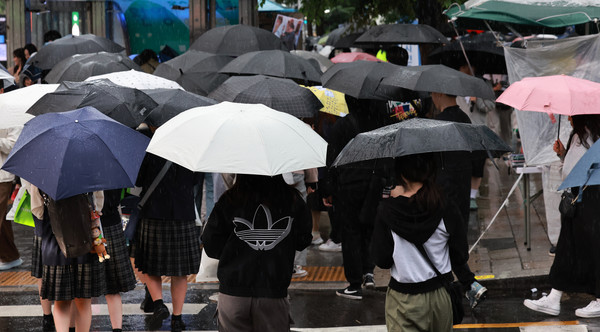 ▲ 비가 내린 15일 오후 서울 마포구 홍대입구역 인근에서 시민들이 우산을 쓰고 걸어가고 있다.  사진=뉴시스