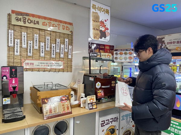 고객이 GS25에서 군고구마 등 동절기 먹거리를 구매하고 있다. / GS25
