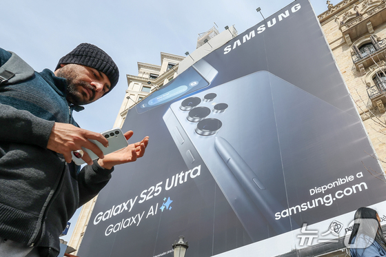 A Galaxy S25 Ultra advertisement is displayed on Gracia Street near Plaça de Catalunya in Barcelona, Spain, two days before the opening of the Mobile World Congress (MWC) 2025. March 2, 2025 / News1 © Min Kyung Seok