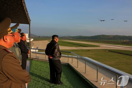 General Secretary of the Workers\' Party, Kim Jong Un, visits the Flying Regiment of the 1st Airborne Division of the Korean People\'s Army. Three drones are flying in the upper right of the photo. / Rodong Sinmun
