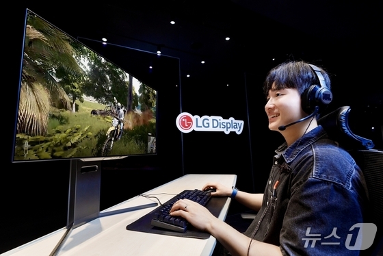 Playing a game on a 27-inch OLED monitor panel with 4th generation technology applied by LG Display / Provided by LG Display