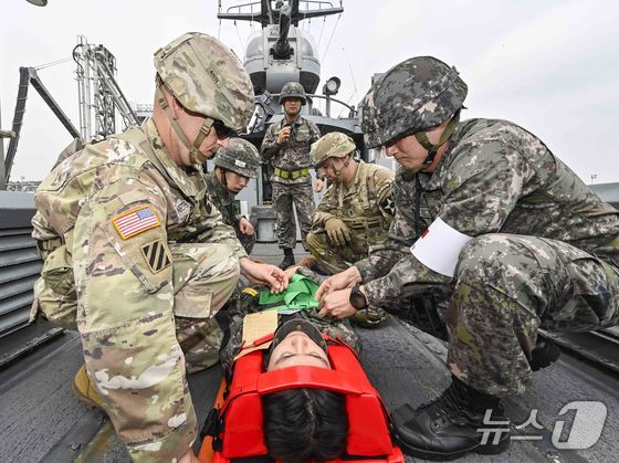 During a combined joint medical support exercise last month, South Korean and U.S. troops secured a Marine with a spinal injury to a stretcher for evacuation via high-speed boat. / Photo courtesy of ROK-US Combined Forces