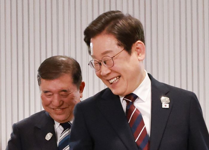 이재명 대통령이 17일(현지시간) 캐나다 앨버타주 캐내내스키스 주요 7개국(G7) 정상회의장에서 열린 한일 정상회담에서 이시바 시게루 일본 총리와 자리를 바꾸며 밝게 웃고 있다. ⓒ연합뉴스