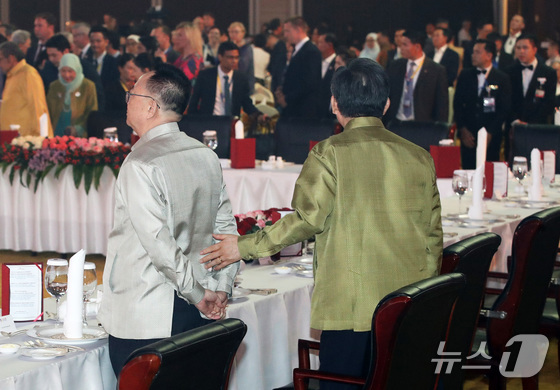 South Korean Foreign Minister Cho Tae Yul approaches North Korean Ambassador to Laos Ri Yong Chol as he speaks to him during the gala dinner of the 57th Association of Southeast Asian Nations (ASEAN) Foreign Ministers\' Meeting at the National Convention Center (NCC) in Vientiane, Laos, on July 26 last year.