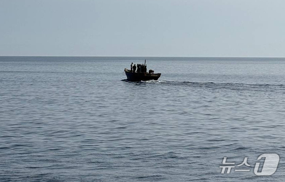 The government repatriated six North Korean residents on Wednesday who had been drifting in the East and West Seas and staying in South Korea. The image shows the residents returning to North Korea on a wooden boat. / Photo courtesy of the Ministry of Unification
