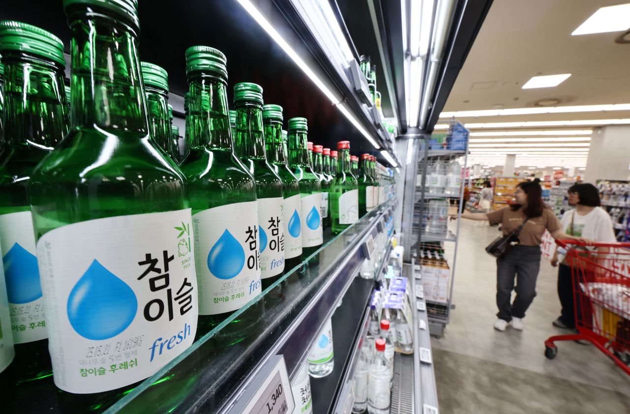 Soju bottles from HiteJinro are displayed at a supermarket in Seoul on June 9. (Yonhap)]
