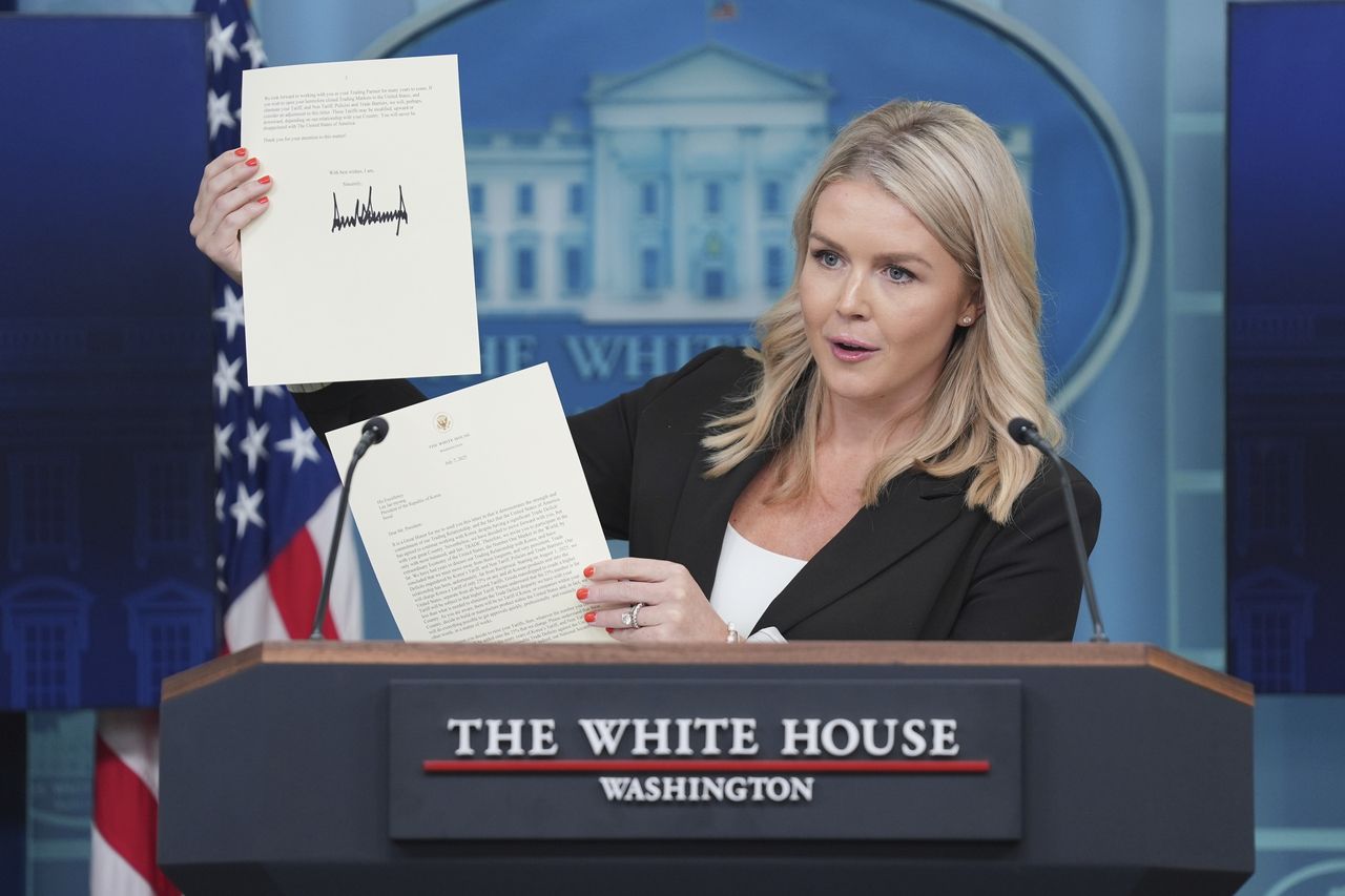 White House press secretary Karoline Leavitt speaks as she holds up a letter from President Donald Trump to South Korean President]