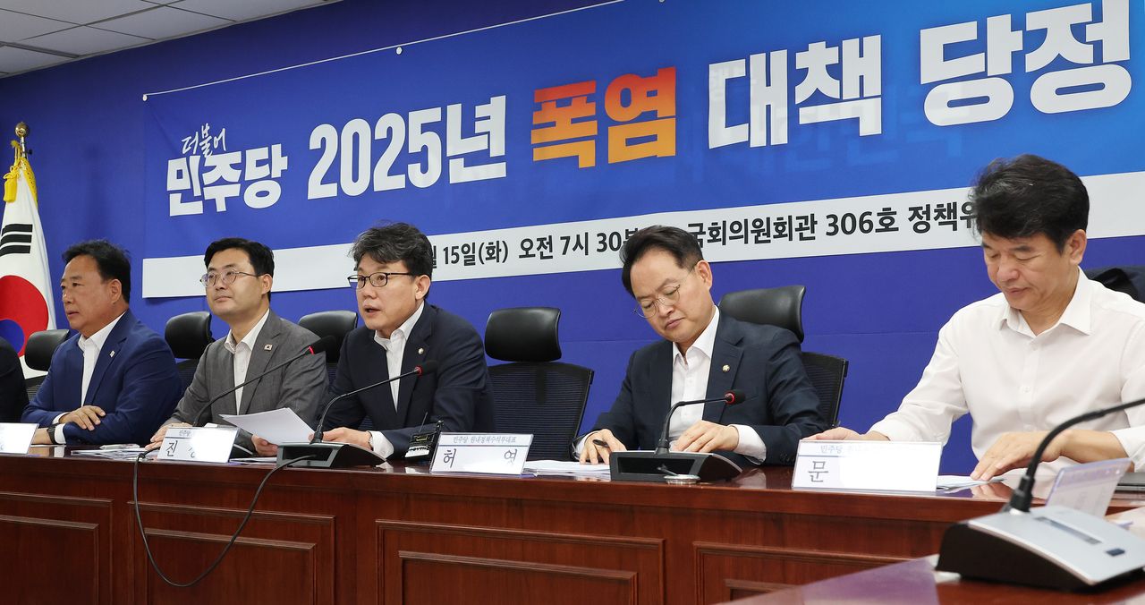 Rep. Jin Sung-joon (center), chairman of the Democratic Party's policy committee, speaks during a meeting with government officials at the National Assembly in Seoul on Tuesday. (Yonhap)