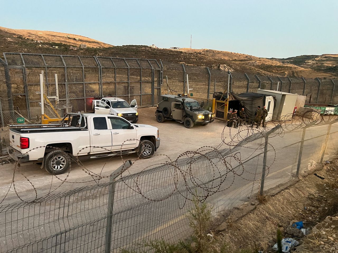 Israeli soldiers stand guard next to a gate on the Golan Heights side, near the ceasefire line between the Israeli-occupied Golan Heights and Syria, in Majdal Shams, in the Israeli-occupied Golan Heights, Tuesday. (Reuters-Yonhap)]