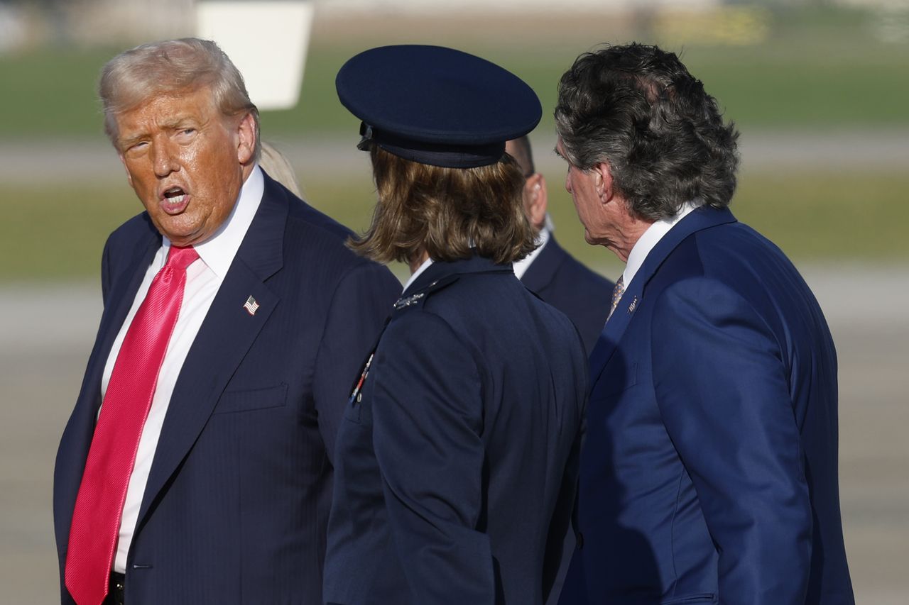 President Donald Trump, left, accompanied by Air Force Col. Angela F. Ochoa, Commander of the 89th Airlift Wing, center, and Secretary of the Interior Doug Burgum, right, walk toward Marine One after speaking to media upon his arrival at Joint Base Andrews on Tuesday. (AP)]