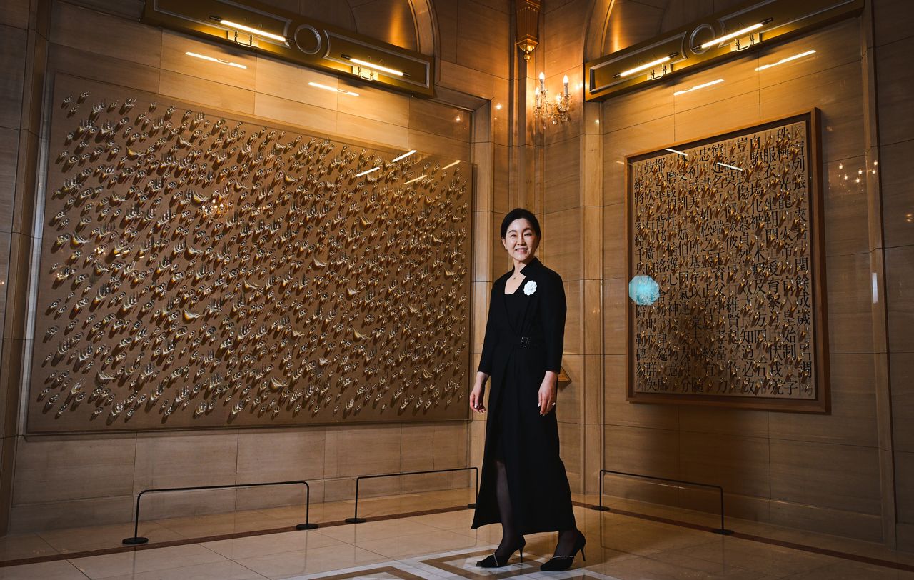 Kim Soo-hyun, owner of The L. Collection at Lotte Hotel Seoul, poses for a photo on July 9 in front of paintings by Kim Tschang-yeul on display at the hotel