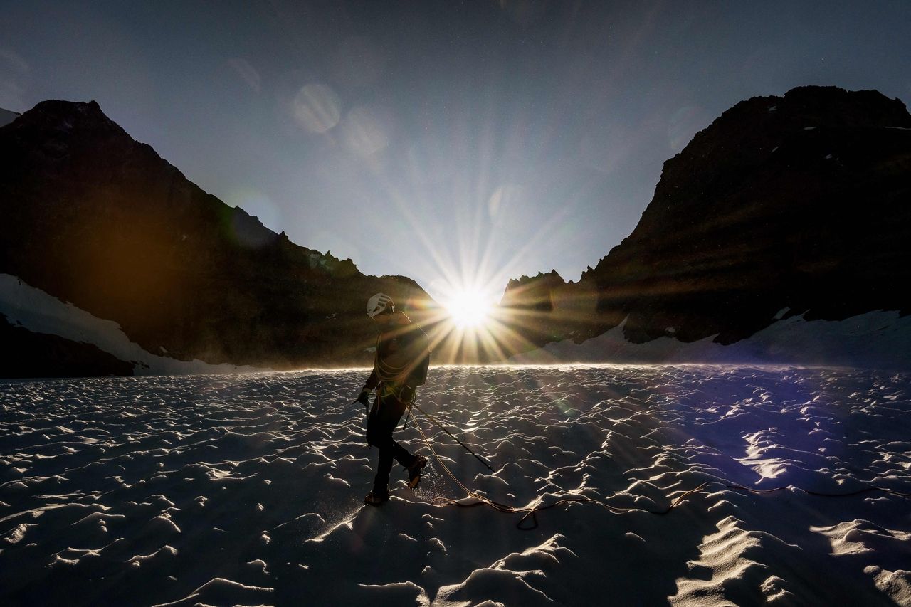 A mountaineer walks on the Glacier de la Selle in the Ecrins Massif in Saint-Christophe-en-Oisans, early in the morning on July 9. (AFP-Yonhap)]