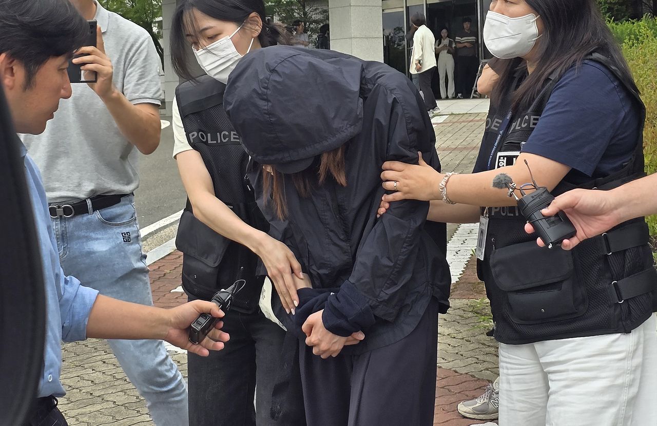 The mother of a high school student, accused of stealing exam papers for her daughter]