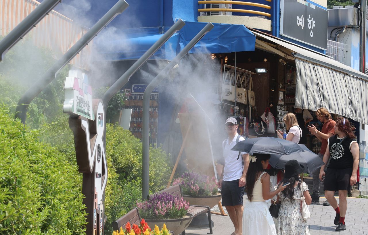 Foreign nationals are seen walking in Saha-gu, Busan, in this July 8 photo. (Yonhap)