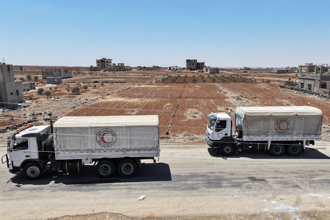 A Syrian Red Crescent convoy carrying aid provided by Syrian]
