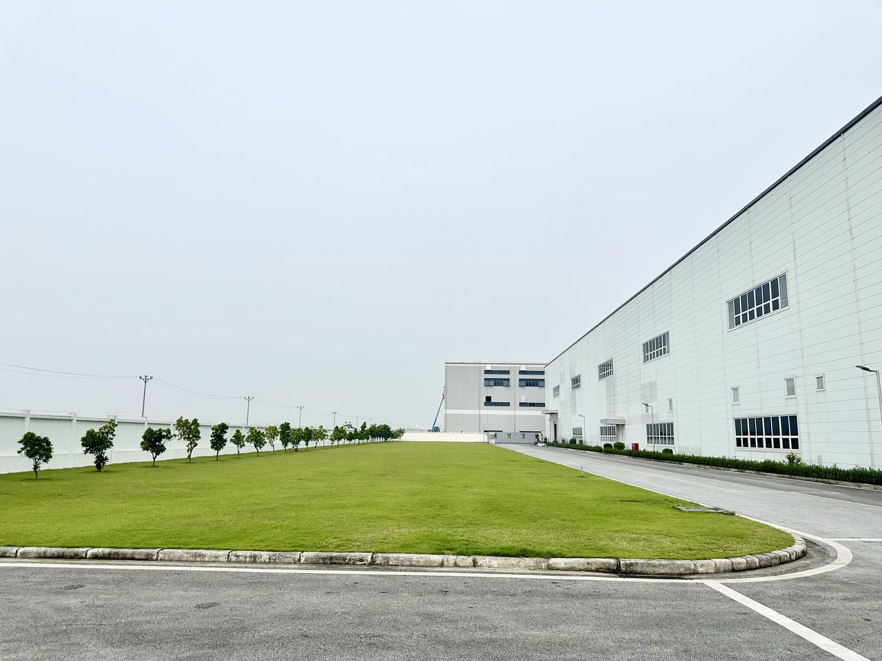Choi Jong-hoon (center), general director of LS Electric Vietnam, inspects the Power system panel assembly line at LS Electric's Bac Ninh plant, east of Hanoi, Vietnam, on July 16. (Byun Hye-jin/The Korea Herald)