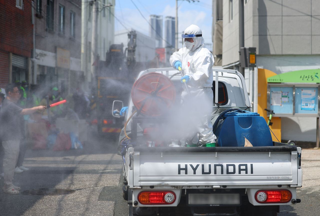 Authorities conduct flood recovery and disinfection work in Gwangju on July 20. (Yonhap)