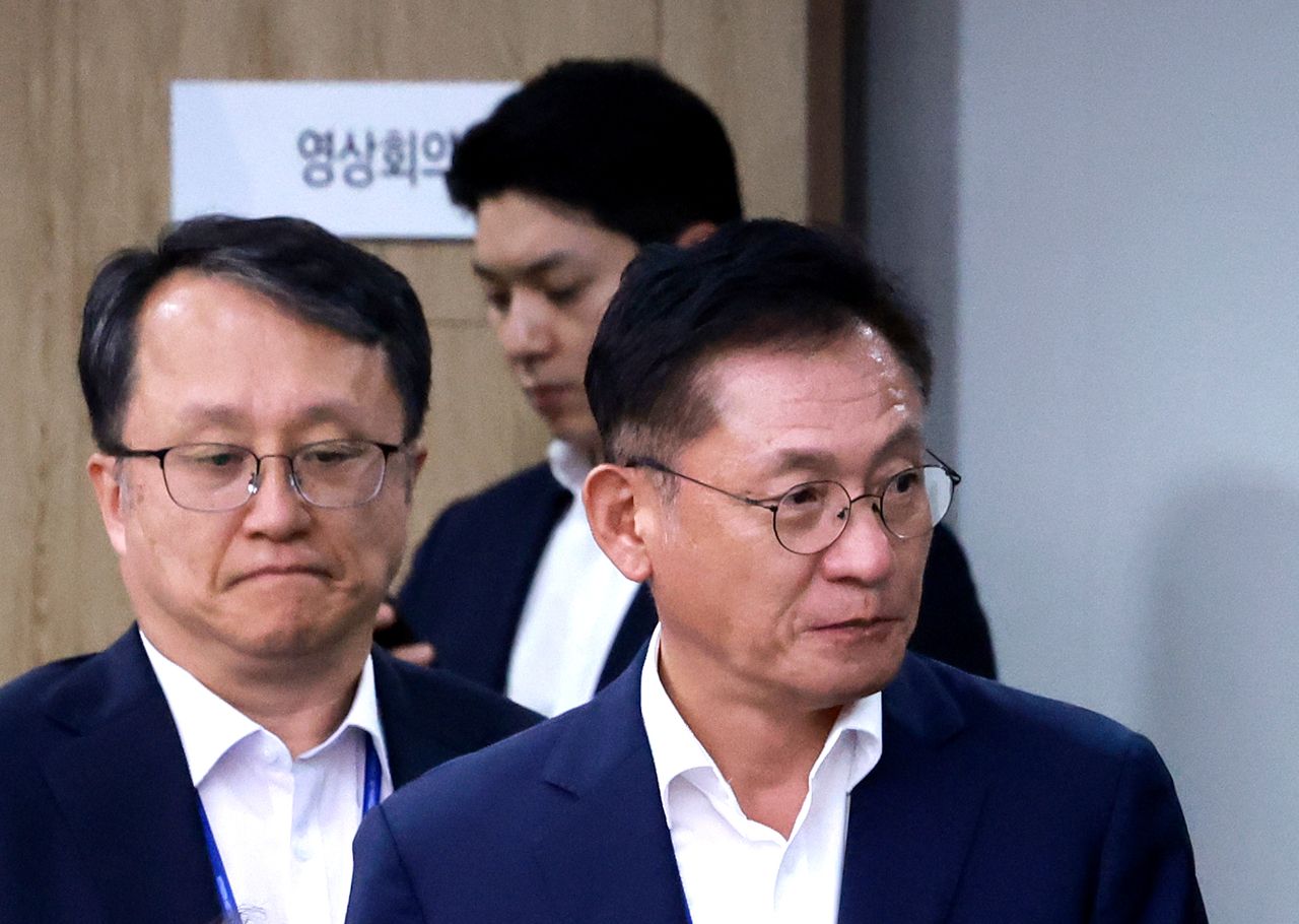 Kang Jun-wook (left), the presidential secretary for national integration, enters a meeting of presidential senior aides and secretaries held at the presidential office in Seoul on Tuesday. (Yonhap)]