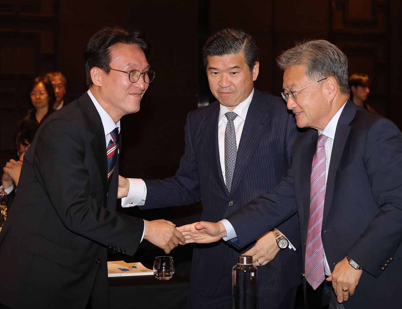 South Korean Prime Minister Kim Min-seok (left) shakes hands with Joseph Yun, charge d]