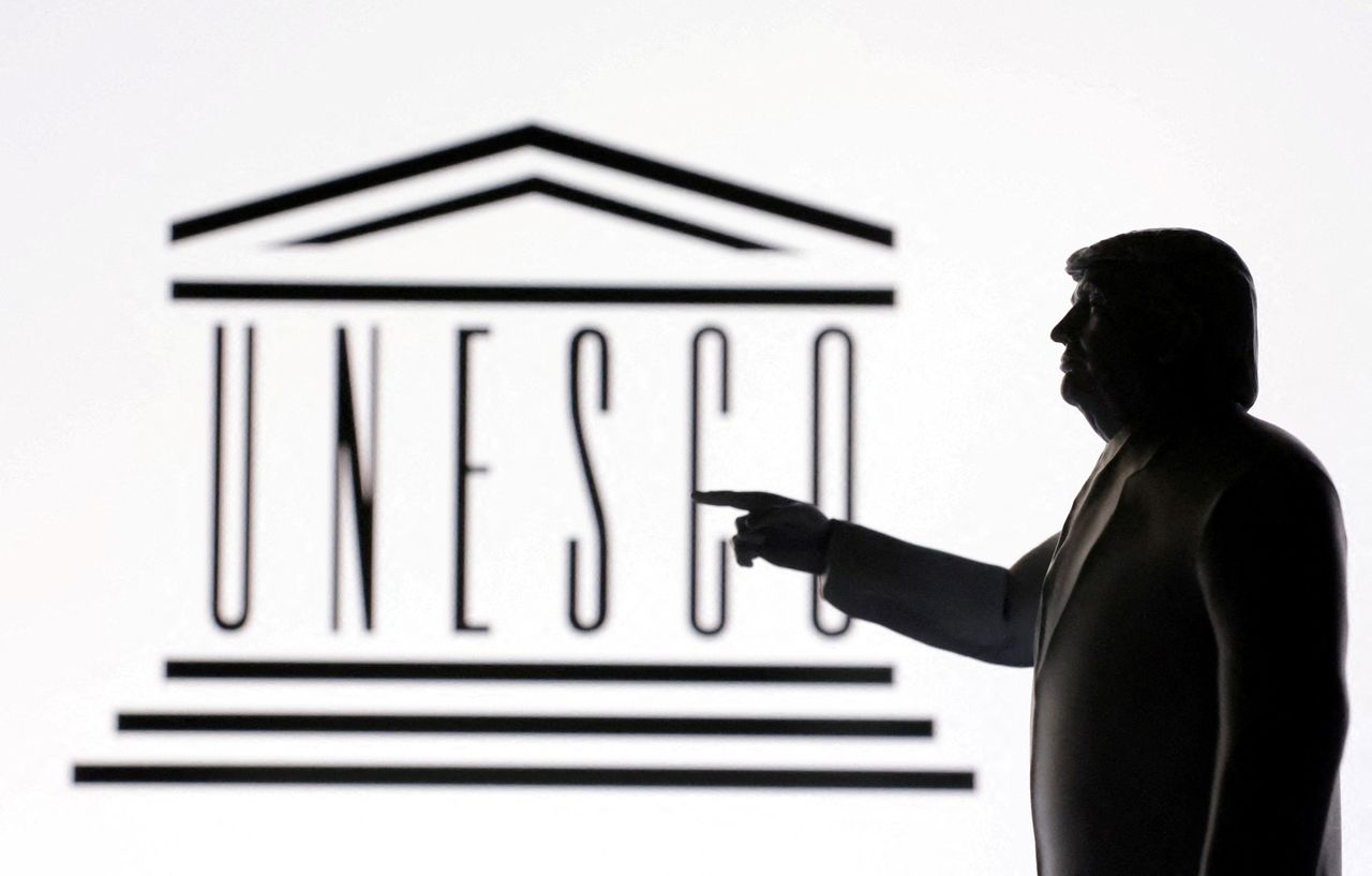 A 3D-printed miniature model of US President Donald Trump with the UNESCO logo in the background is seen in this illustration taken April 23. (Reuters-Yonhap)]