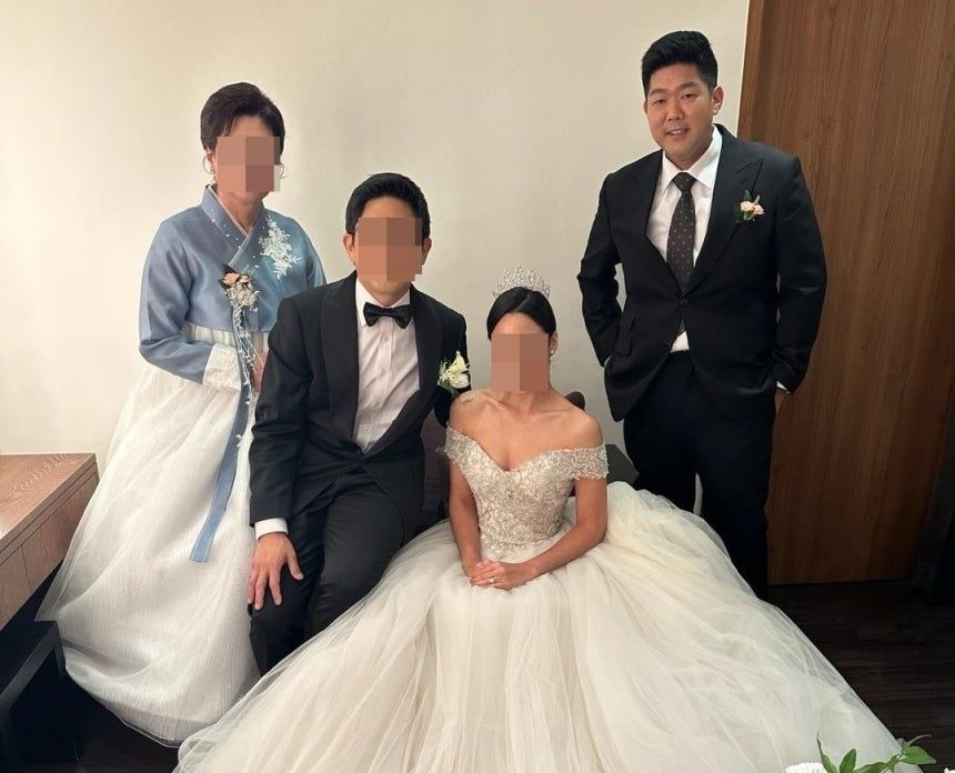 Tae-heung Kim (far right), who is being detained by US immigration authorities, is seen in a photo taken at his brother's wedding. (The National Korean American Service & Education Consortium)]