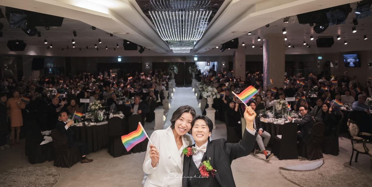 Lesbian couple Gwak I-kyung and Kim Hana celebrate their wedding ceremony, which Han helped organize, on Jan. 13, 2024. (Instagram @dan_photograph_)]