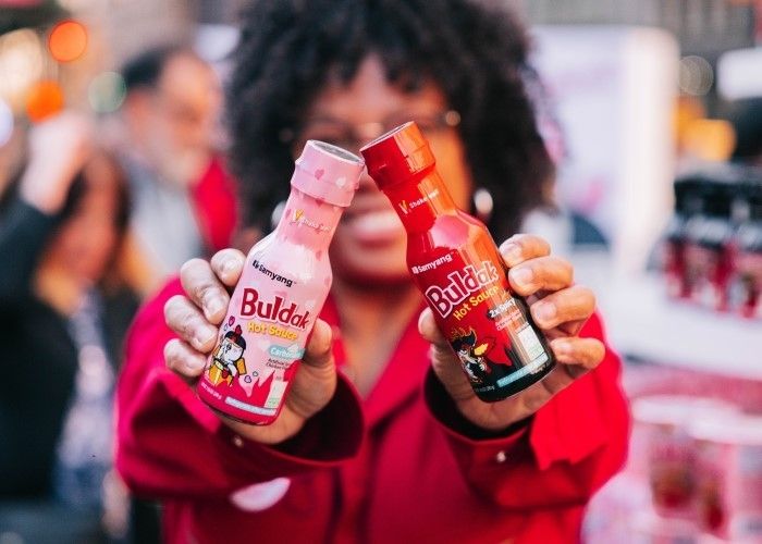 A customer holds bottles of Samyang]