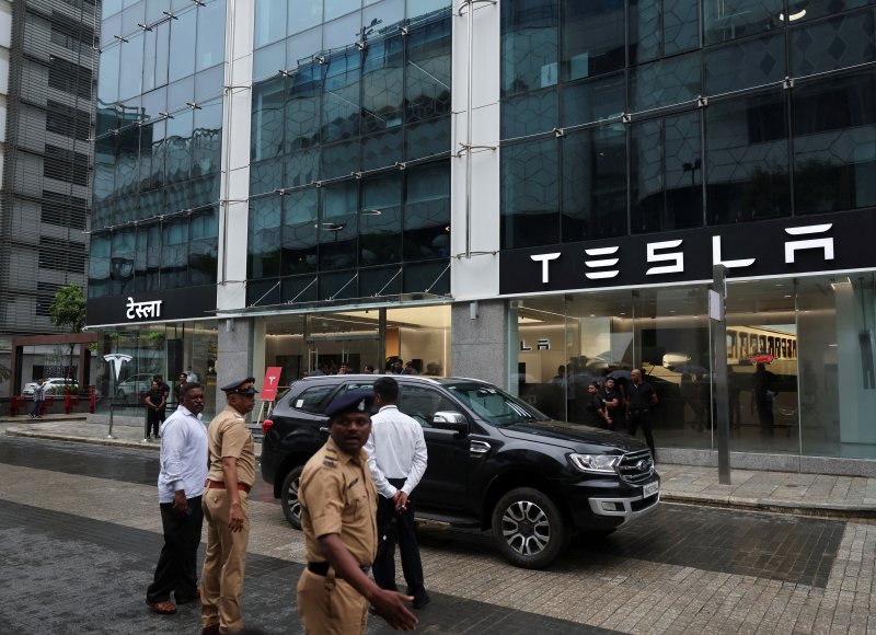 Police officers managing traffic outside Tesla\'s new showroom in Mumbai, India / Photo courtesy of Reuters
