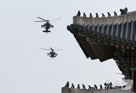 Two Boeing AH-64 Apaches of the Republic of Korea Army conduct a rehearsal flight for the 76th Armed Forces Day commemoration over central Seoul on the afternoon of August 14. 2024.8.14 / News1