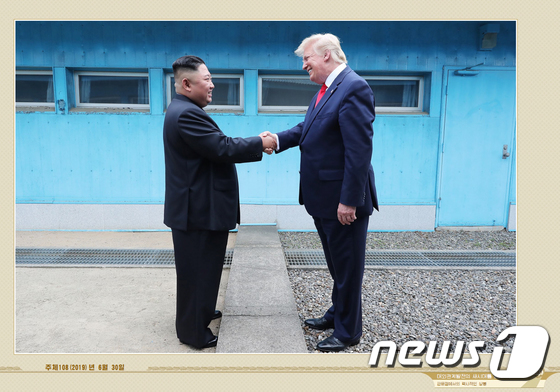 North Korean leader Kim Jong Un and U.S. President Donald Trump shake hands across the military demarcation line at Panmunjom on June 30, 2019 in this photo released on May 12, 2021 by North Korea\'s Foreign Literature Publishing House, titled, Unleashing a New Era in the Development of Foreign Relations (Capture from foreign-language publisher photos) 2021.5.12 / News1
