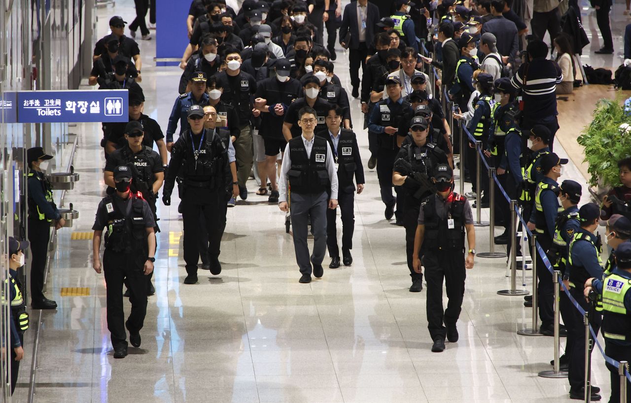 South Koreans detained in Cambodia for involvement in online scams are repatriated through Terminal 2 of Incheon International Airport on Saturday morning. (Yonhap)