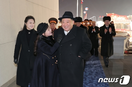 North Korea\'s Kim Jong Un, General Secretary of the Workers\' Party, descends from the reviewing stand with his daughter Ju-ae after a military parade marking the 75th anniversary of the founding of the Korean People\'s Army in February 2023 / Rodong Sinmun