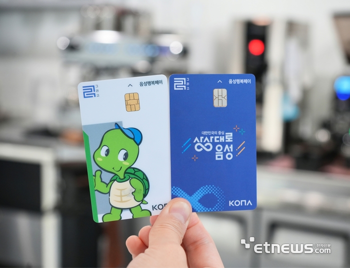 음성군 골목상권에서 음성사랑상품권 '음성행복페이'를 들어 보이고 있다.