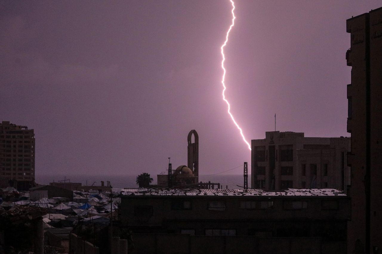 A bolt of lightning illuminates the sky over the ruins west of Gaza City, Gaza Strip, Monday. (EPA-Yonhap)