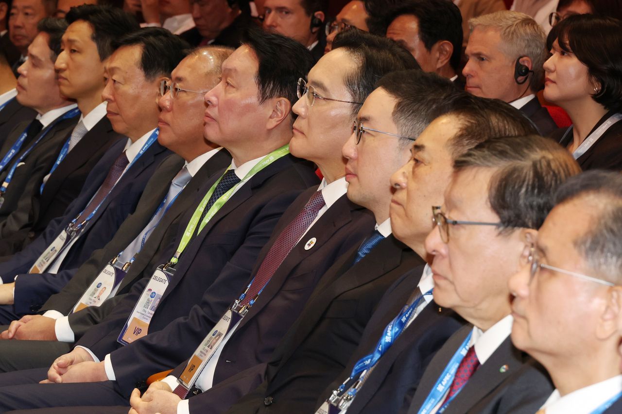 From left: Shinsegae Group Chair Chung Yong-jin, HD Hyundai Chair Chung Ki-sun, Lotte Group Chair Shin Dong-bin, Hyundai Motor Group Executive Chair Chung Euisun, SK Group Chair Chey Tae-won, Samsung Electronics Chair Lee Jae-yong, LG Group Chair Koo Kwang-mo, Posco Group Chair Chang In-hwa, GS Group Chair Huh Tae-soo and Hanwha Group Vice Chair Yeo Seung-joo listen to President Lee Jae Myung's opening speech for the APEC CEO Summit 2025 held at the Gyeongju Arts Center on Oct. 29. (Yonhap)