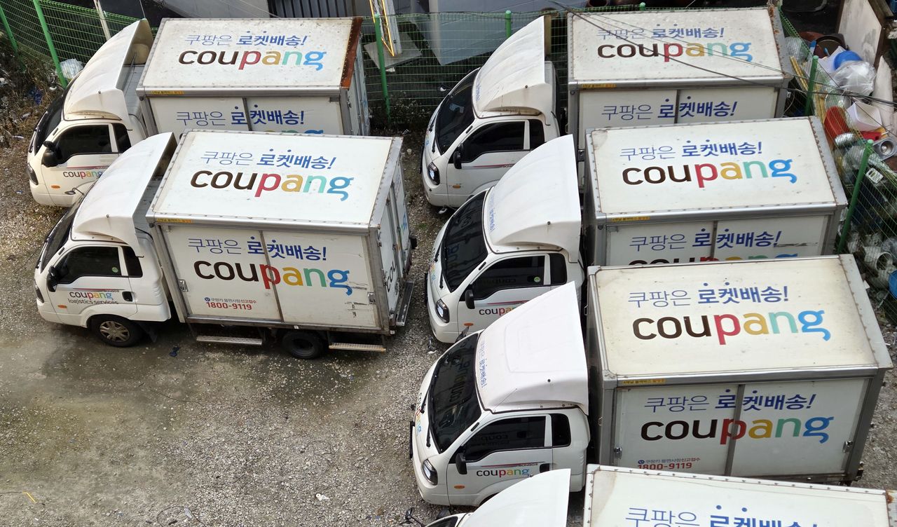 Coupang's delivery trucks are parked at a lot in Seoul on Sunday. (Yonhap)