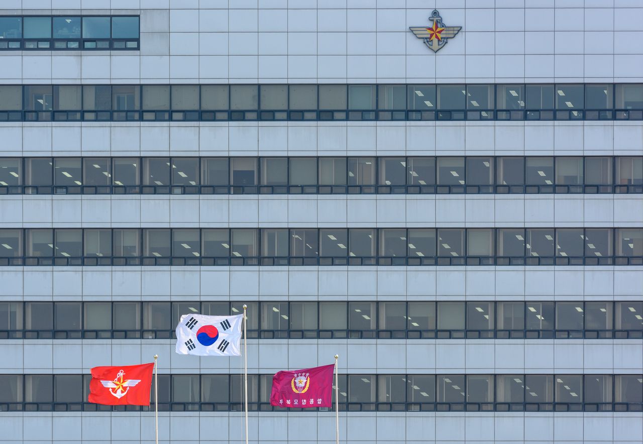 The South Korean national flag (center), the Defense Ministry flag (left) and the Joint Chiefs of Staff flag fly outside the Defense Ministry headquarters in Seoul. (Getty Images)