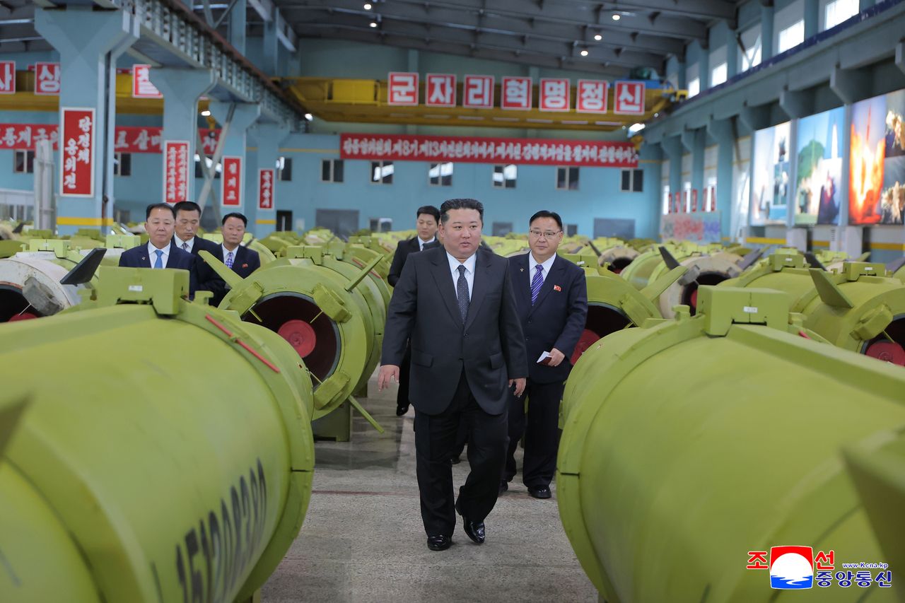 North Korean leader Kim Jong-un (C) inspects major munitions factories while calling for expanding the production of missiles and shells. (KCNA via Yonhap)