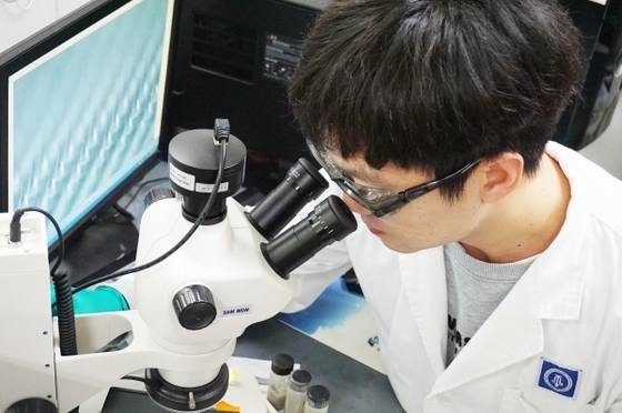 A CKD BiO researcher is conducting analytical research using a microscope (Provided by CKD BiO / News1