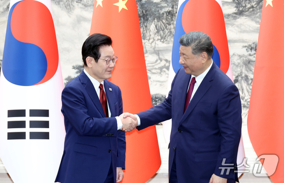 President Lee Jae Myung and Chinese President Xi Jinping shake hands at the Great Hall of the People in Beijing on January 5 2026.1.5 / News1