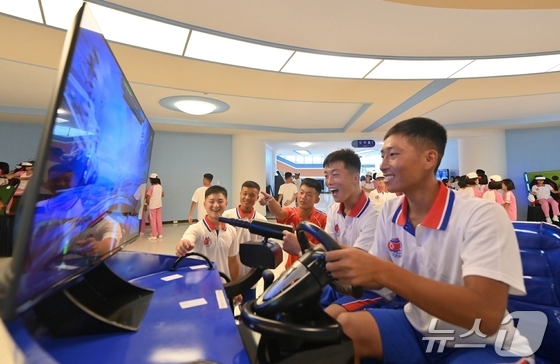 North Korean students visiting the Wonsan Kalma Coastal Tourist Zone enjoying electronic games / Rodong Sinmun