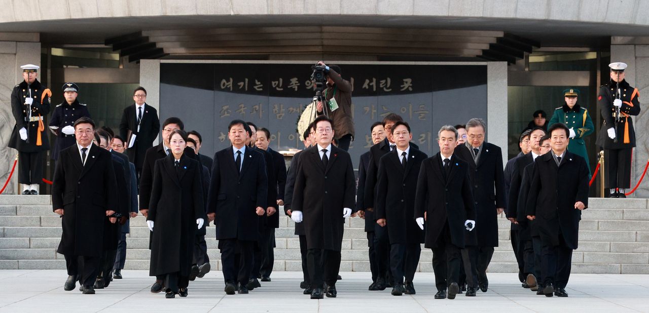 President Lee Jae Myung moves on after paying respects at the Seoul National Cemetery on New Year’s Day, Thursday. (Yonhap)