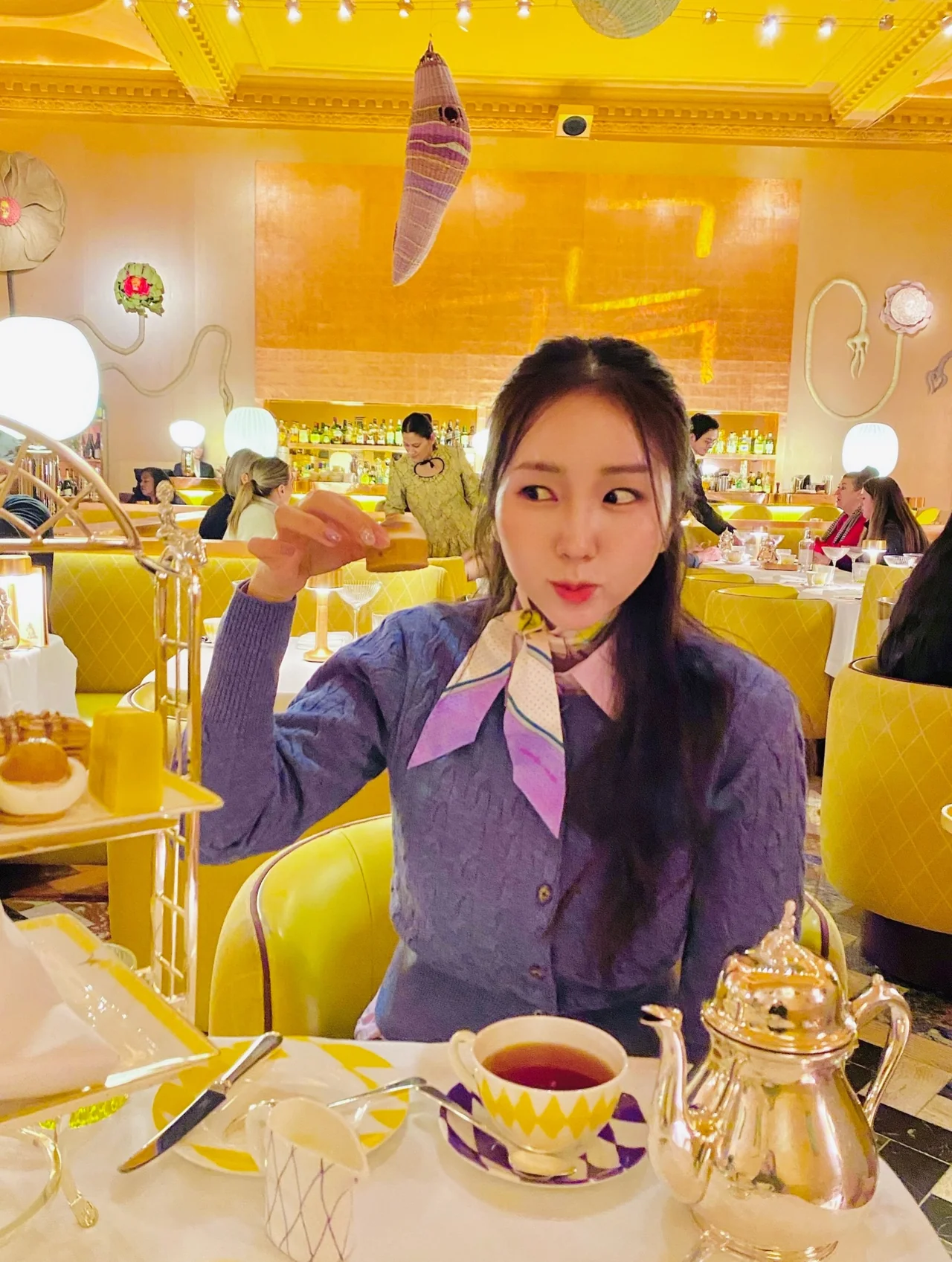 &nbsp;     Purple Cardigan & Patterned Scarf | Tea Time Chic: How to Look Like an Intellectual Broadcaster in London\'s Hippest Tearoom / Photo: Park Ji-hye Instagram