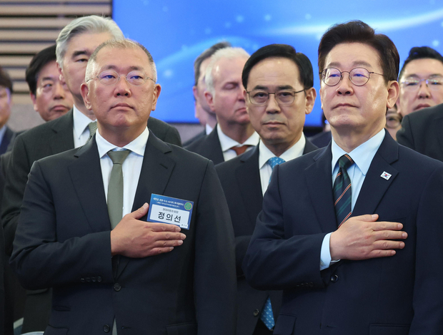 이재명 대통령과 정의선 현대자동차 회장이 27일 전북 군산시 새만금 컨벤션센터에서 열린 새만금 로봇·수소·AI 시티 투자협약식에서 국민의례를 하고 있다.  뉴스1