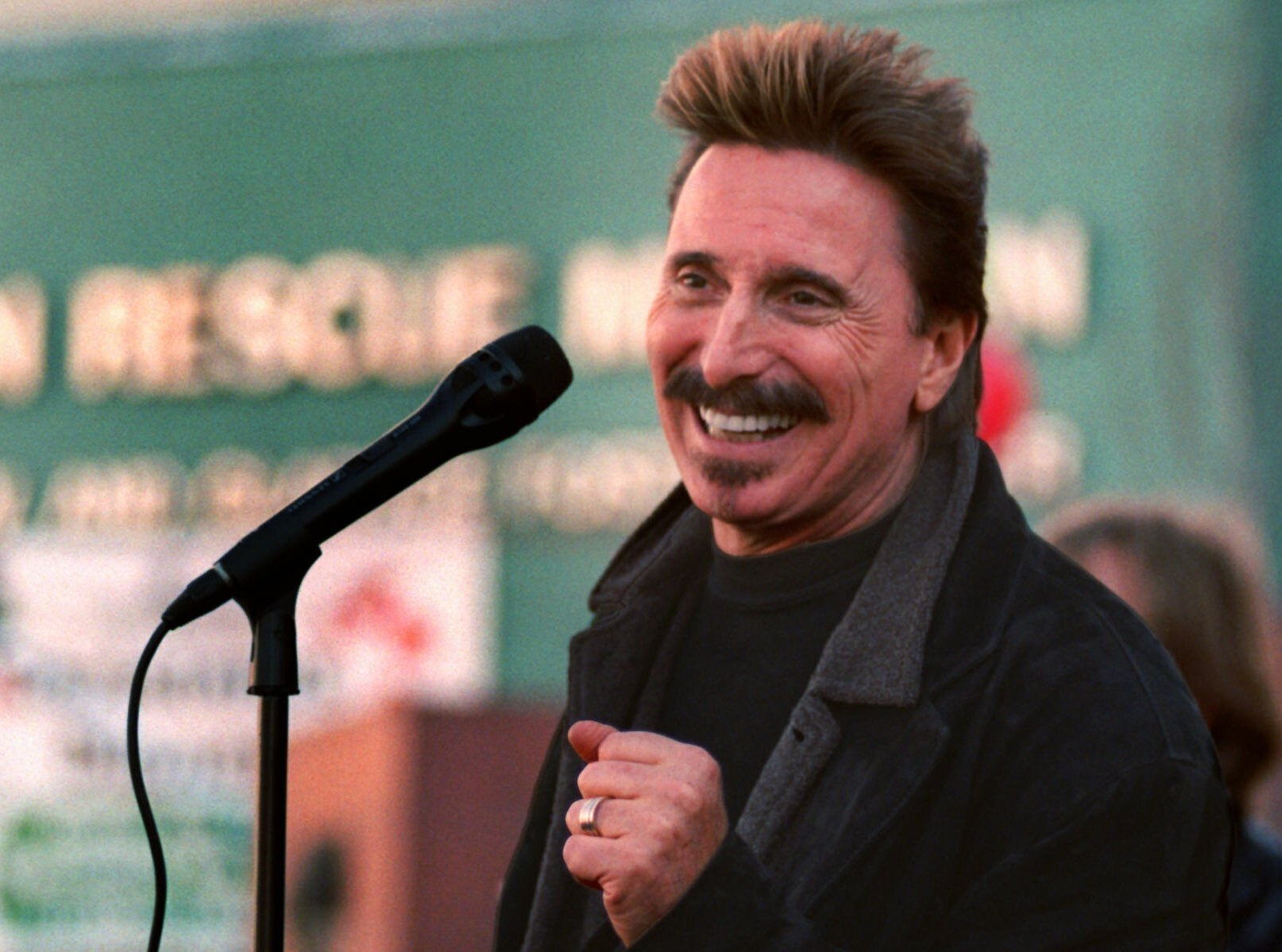 Chuck Negron, former lead singer of Three Dog Night, sings to a crowd during a Christmas Eve party, Dec. 24, 1997, at the Union Rescue Mission in Los Angeles. (AP Photo/John Hayes, File)