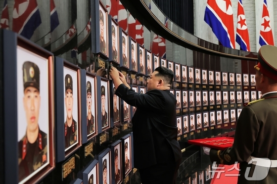 A scene showing Kim Jong Un, General Secretary of North Korea\'s Workers\' Party, paying his respects in front of a photograph of a soldier killed in action in Russia / Rodong Sinmun