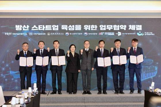 Minister Han Seong-sook of the Ministry of SMEs and Startups (fourth from the left), Director Lee Yong-chul of the Defense Acquisition Program Administration (fifth from the left), and other attendees are posing for a commemorative photo / Provided by the Ministry of SMEs and Startups
