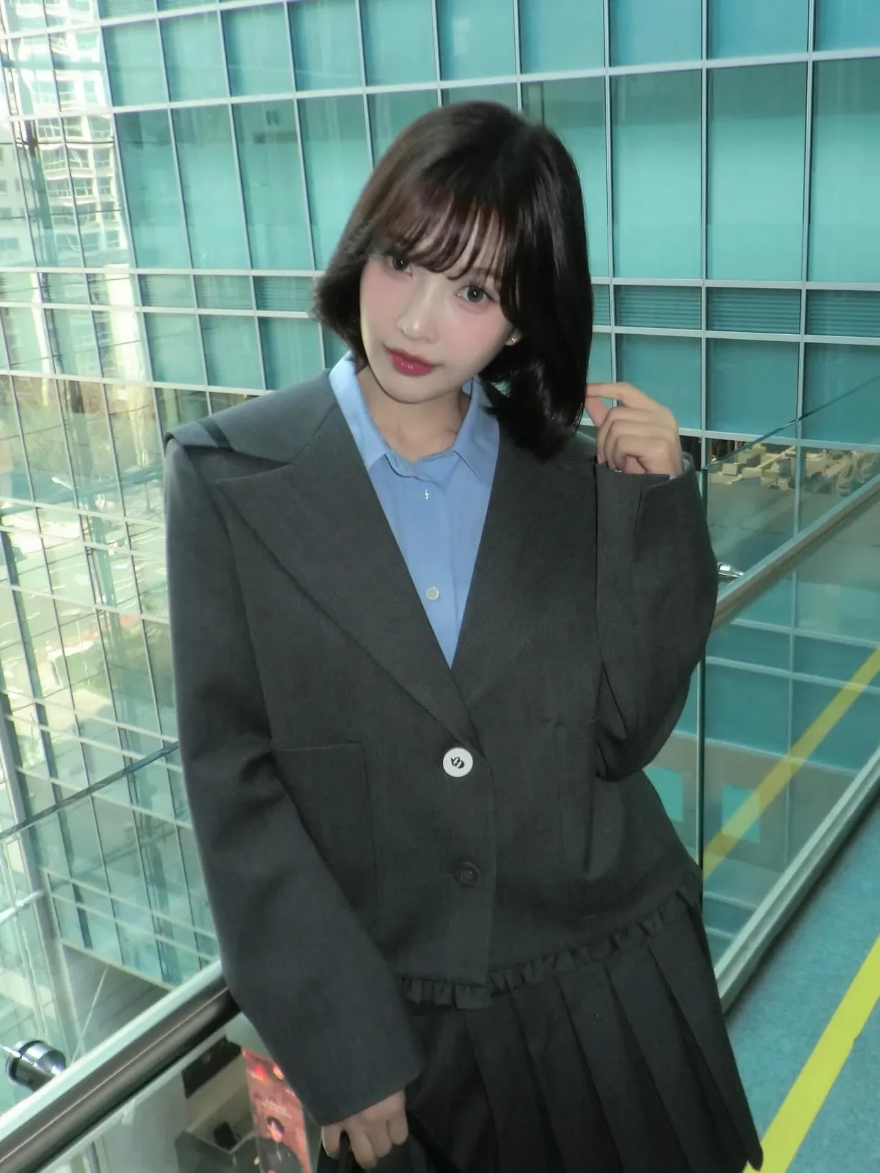 &nbsp;     Joy models a chic commute look with a dark blazer, pleated mini skirt, and black knee-high boots. /Photo=Joy Instagram